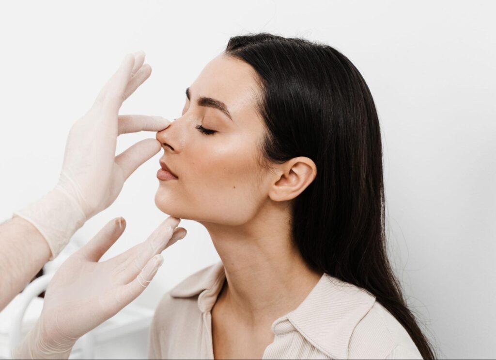surgeon assessing nasal fracture and breathing in Englewood