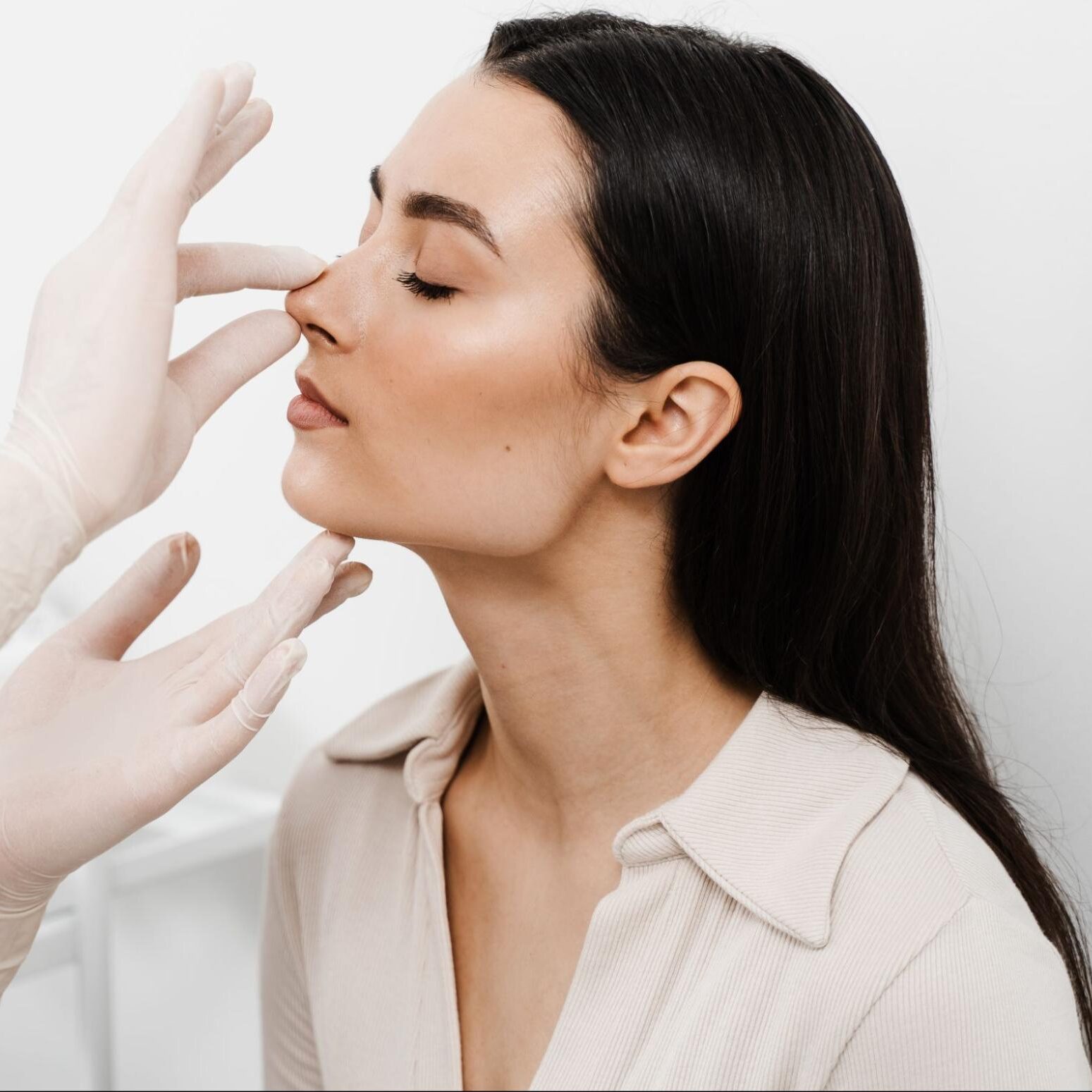 Woman receiving nasal assessment for potential deviated septum surgery by Dr. Monica Tadros, focusing on improving breathing and sleep quality in Manhattan.